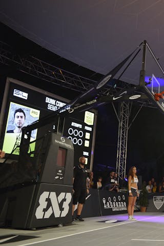Dunking over two cheerleaders at the dunk contest 2013 FIBA 3x3 World Tour Masters in Lausanne